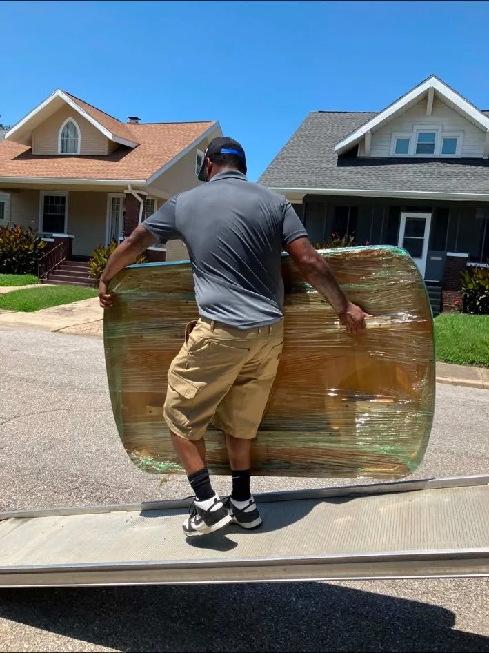 Mover carrying wrapped furniture